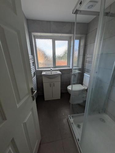 a small bathroom with a toilet and a sink at 6 bedroom house Trochetia in Crawley