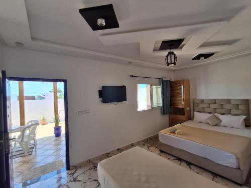 ein Wohnzimmer mit Bett und Balkon in der Unterkunft Studio pêcheur in Oualidia