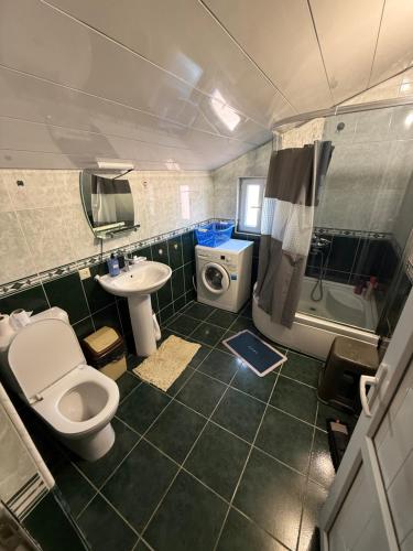 a bathroom with a toilet and a sink and a shower at Home in Mtskheta in Mtskheta