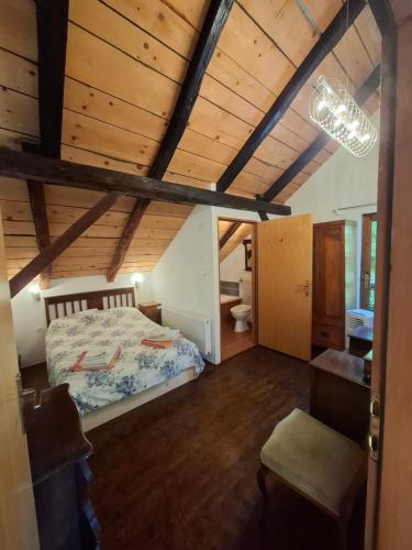 a bedroom with a bed and a wooden ceiling at Villa Rustica in Hruškovica