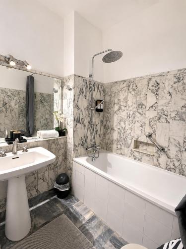 a bathroom with a tub and a sink and a bath tub at Champs elysees apartment 4 in Paris