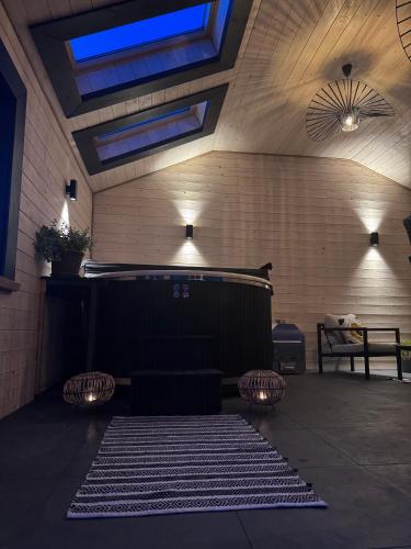 a room with a tub and a rug on the floor at Wooden House Kaszuby in Borsk