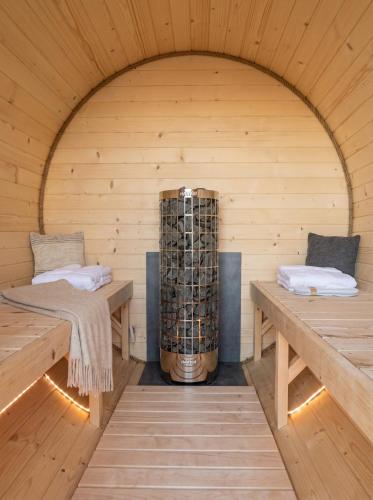 a sauna with two benches and a large cylinder at Villa Taternik - Studio Apartment - Mountain View in Zakopane