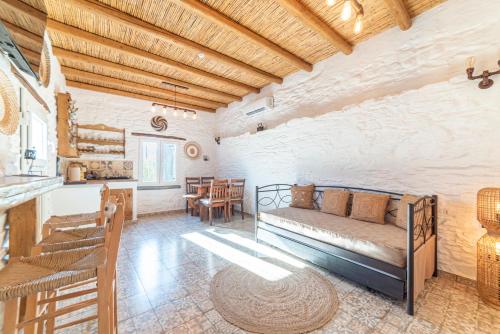 a living room with a couch and a table at Aloni Houses Kythnos in Loutra