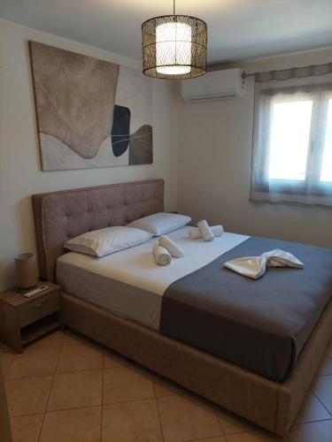 a bedroom with a bed with two shoes on it at Μοντέρνο Σπίτι in Monemvasia