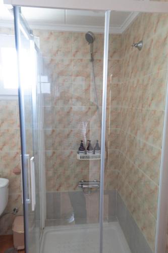 a shower with a glass door in a bathroom at Comfortable and Elegant Seafront Apartment in Faro de Cullera