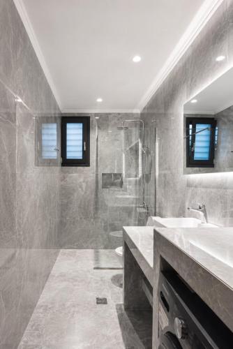 a bathroom with a sink and a shower at Lion Exclusive Villa in Sarakinádhon