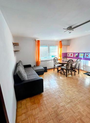 a living room with a couch and a table at Signature events in Malečnik