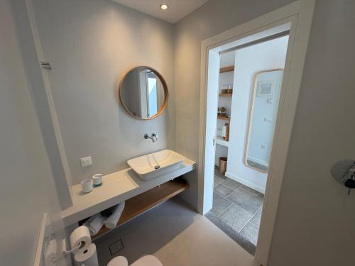 a bathroom with a sink and a mirror at Myrto Hotel in Kamares