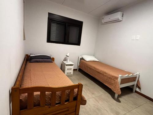 a bedroom with two beds and a window at La Hojarasca in Termas de Guaviyú