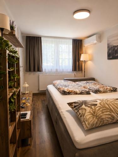 a hotel room with two beds and a table at Romantic Mirka Apartment in Sremski Karlovci in Sremski Karlovci