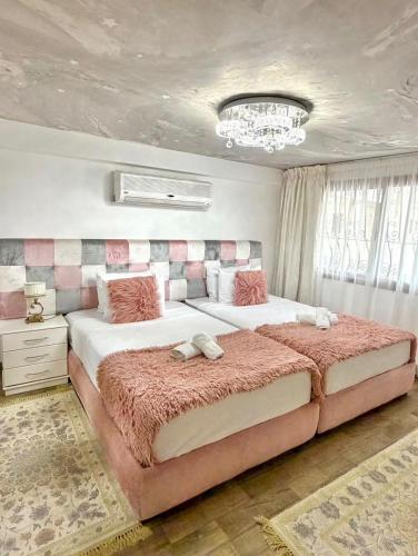 a bedroom with two beds and a chandelier at Tanger Achakar in Tangier