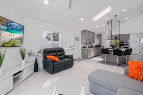 a living room with a couch and a kitchen at Luxury New Build Bright 2BR 2BA Large Backyard in Mission Viejo