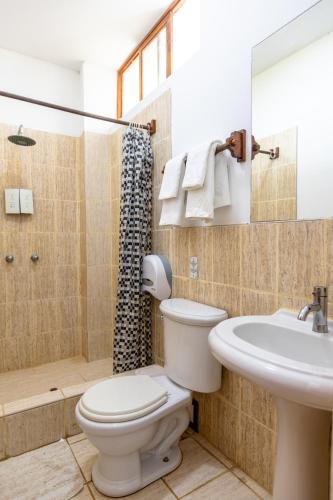 a bathroom with a toilet and a sink and a shower at Costa Beach in Zorritos