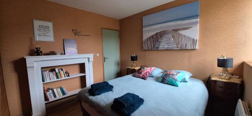 a bedroom with a bed with blue pillows on it at Manoir des Nobles Cœurs et Spa in Saint-Donan