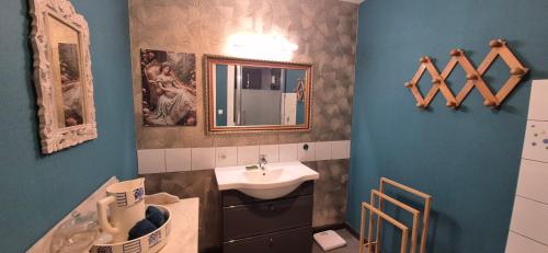 a bathroom with a sink and a mirror at Manoir des Nobles Cœurs et Spa in Saint-Donan