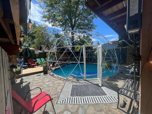 a swimming pool with a swing in a yard at Quaint Attic Suite with Heated Pool Year-Round in Victoria