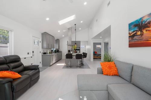 a living room with a couch and a kitchen at Luxury New Build Bright 2BR 2BA Large Backyard in Mission Viejo