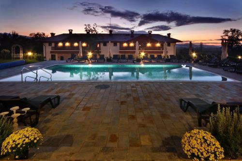 a swimming pool in front of a house at Esterra Vini Guest House in Perushtitsa