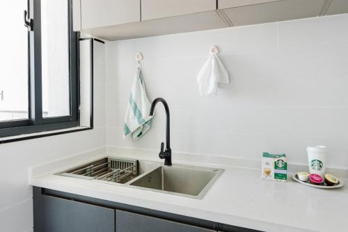 a kitchen counter with a sink and a window at Ultimate Safari Retreat,9min to Nairobi JKIA with Pool,Gym,WiFi and Binocular views in Nairobi