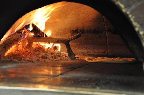 a pizza is cooking in a pizza oven at Hotel Argegno in Argegno