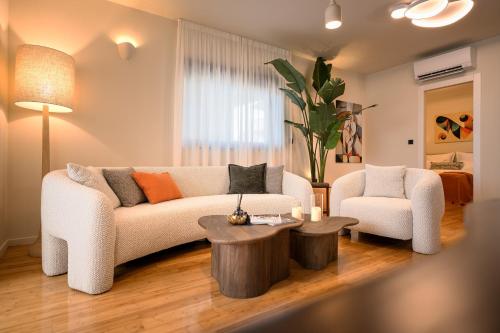 a living room with a couch and a coffee table at Maslina Residence - Hvar in Hvar