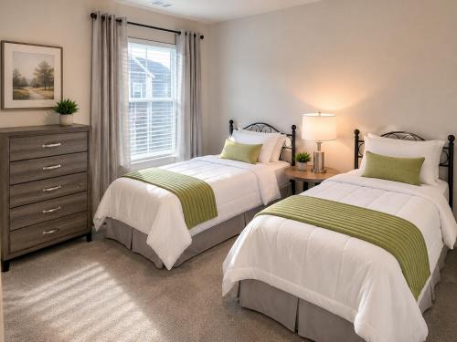a bedroom with two beds and a window at Collin Creek Executive Residence in Plano