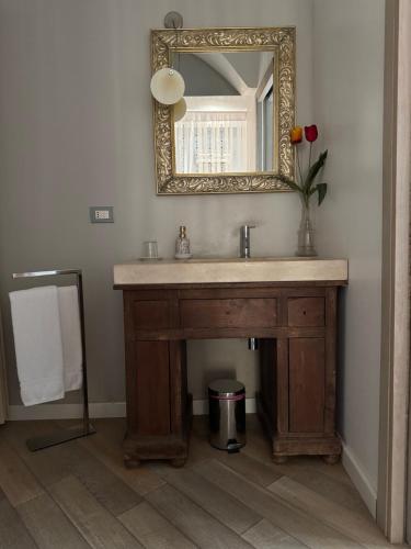 a bathroom with a sink and a mirror at Le Lumie in Modica