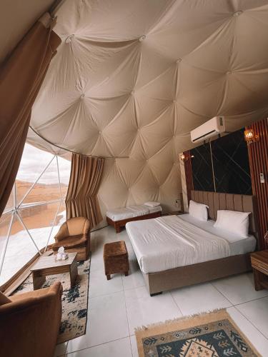 a bedroom with a bed in a tent at Natalie Wadi Rum camp & Jeep tour in Wadi Rum