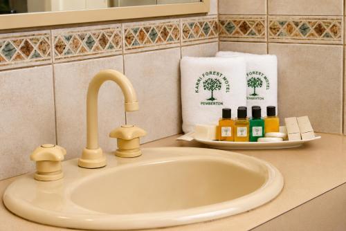 a bathroom sink with a faucet and a towel at Karri Forest Motel in Pemberton