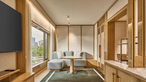 a room with a table and chairs and a window at Holiday Inn Singapore Orchard City Centre by IHG in Singapore