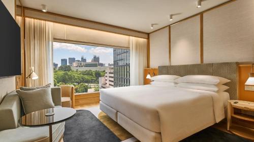 a hotel room with a bed and a large window at Holiday Inn Singapore Orchard City Centre by IHG in Singapore