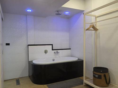 a bathroom with a bath tub in a room at Bangkok Sleep Nest in Sathani Ban Hua Mak