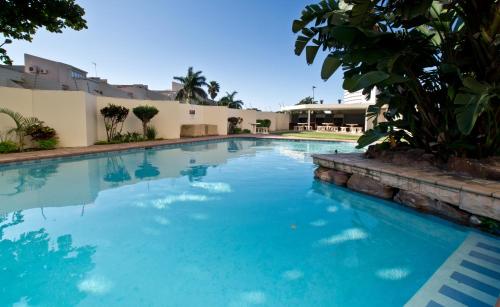 a large swimming pool with blue water at 43 Sea Lodge - by Stay in Umhlanga in Durban