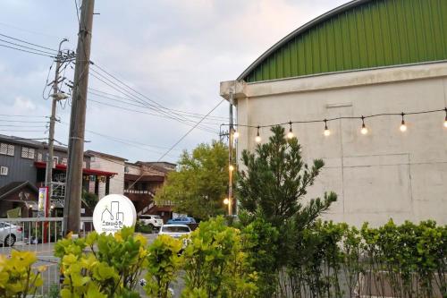 a building with a string of lights on it at Stay Suncheon in Suncheon