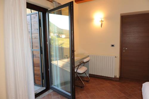a room with a desk and a chair next to a window at Country House Il Papavero in Bagnoli Irpino