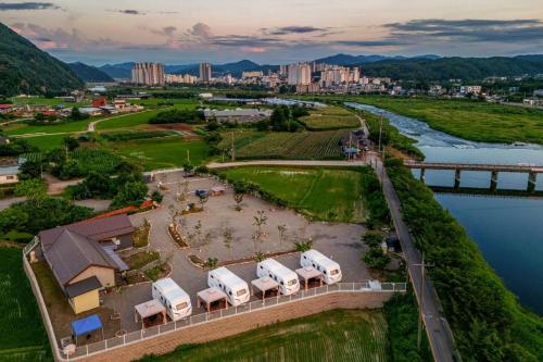 an aerial view of a resort with a river and a city at Gapyeong JY Camping Caravan in Gapyeong