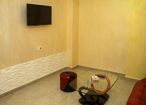 a corner of a room with a tv on a wall at Mirage Hotel in Yerevan