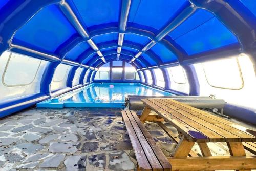 a swimming pool with a wooden table in a tunnel at Pocheon Choice Camp Caravan in Pocheon