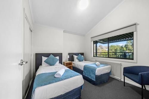 a bedroom with two beds and a window at Sovereign Views Apartments in Ballarat