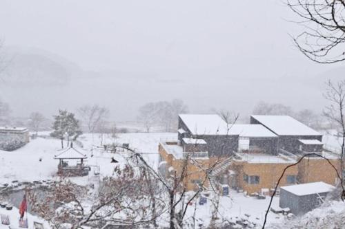 a town covered in snow with buildings at Seocheon Water Willow Pension in Seocheon