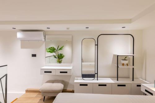 a bedroom with a bed and two mirrors at Hotel&Apartaments -Villa Hasani 24 in Sarandë