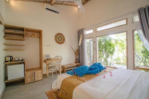 a bedroom with a large bed with a large window at Drift Hideaway- Adult only in Kuta Lombok