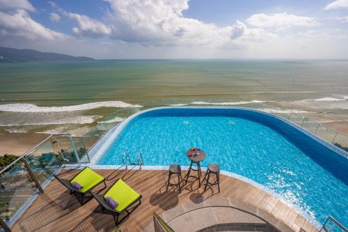 an overhead view of a swimming pool and the ocean at Nesta Celia Danang Hotel in Danang