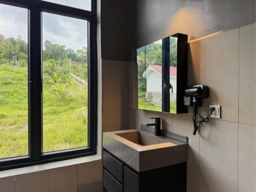 a bathroom with a sink and a large window at Alicia Resort in Koh Rong Island