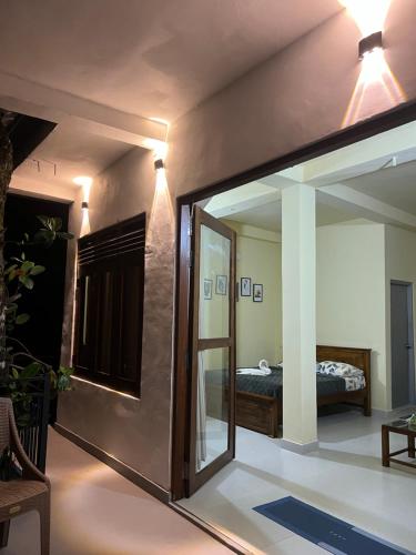 a room with a mirror and a bed in a room at Donald House Cabana Kandy in Kandy