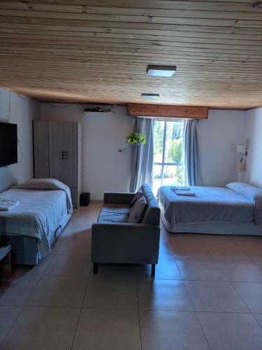 a living room with two beds and a couch at Deptosxdia in Perito Moreno