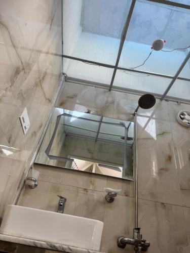 a bathroom with a sink and a mirror at Casa Azul Mountain Resort in Nathia Gali