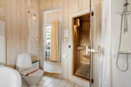 a bathroom with a toilet and a glass door at FY141-Middelfart-Regulusvej-13 in Middelfart