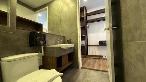 a bathroom with a white toilet and a sink at The RiverKwai Bridge Resort 2 in Ban Chuk Kum